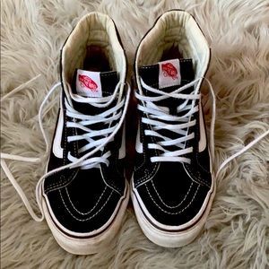Vans black and white high top sneakers.